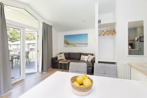 a living room with a couch and a table at Ferienhäuser Lübecker Bucht Ferienhaus Strandläufer in Haffkrug