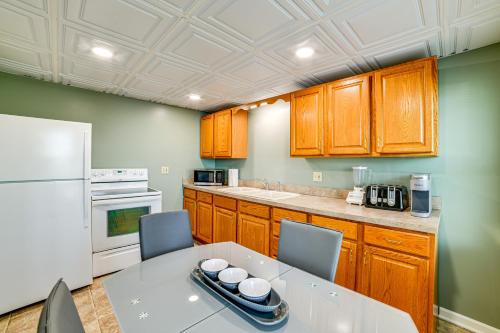 a kitchen with a table and a white refrigerator at Less Than 2 Mi to SUNY Cortland Unit with Private Parking in Cortland