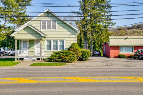 a yellow house on the side of a street at Less Than 2 Mi to SUNY Cortland Unit with Private Parking in Cortland