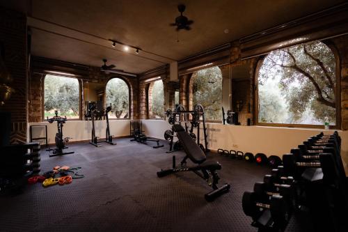 a gym with treadmills and exercise equipment in a room at Olinto, Atlas Mountain Retreat - adults only in Ouirgane