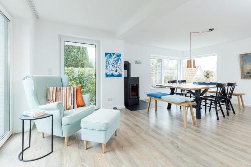 a living room with a table and a chair at Kapitän Clausen in Heikendorf