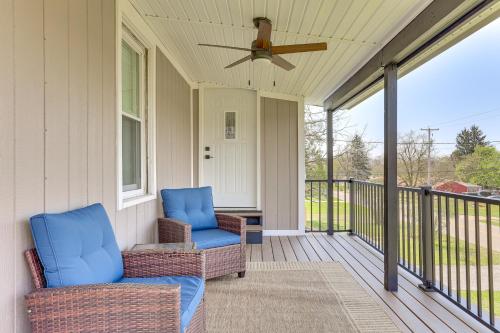 a porch with two chairs and a ceiling fan at 3 Mi to Dtwn Quiet Youngstown Apt with Deck! in Youngstown