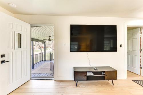 a living room with a flat screen tv on a wall at 3 Mi to Dtwn Quiet Youngstown Apt with Deck! in Youngstown