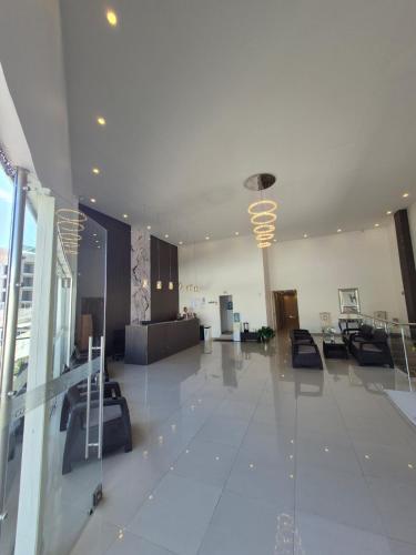 a large room with a lobby with tables and chairs at Apartahotel Plaza in San Andrés