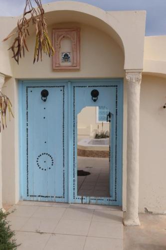 a blue door on the side of a building at Dar El Jerbiya in Midoun