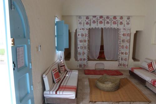 a living room with a couch and a window at Dar El Jerbiya in Midoun