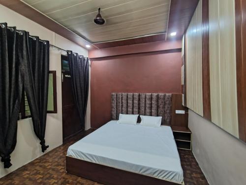 a bedroom with a bed in a room at Down Hill Homestays in Mussoorie