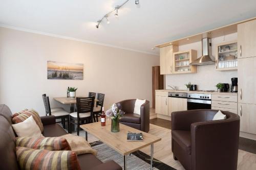 a living room with a couch and a table at Haus Baltic Ostseeidylle in Scharbeutz