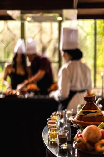 a group of chefs working in a kitchen at Olinto, Atlas Mountain Retreat - adults only in Ouirgane