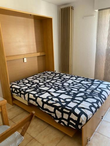une petite chambre avec un lit dans une pièce dans l'établissement T1 résidence privée bien situé,piscine,tennis,parking, à Hyères