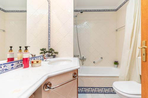 a bathroom with a sink and a shower and a toilet at Quinta Velha Oasis, Pool Resort in Cabanas de Tavira