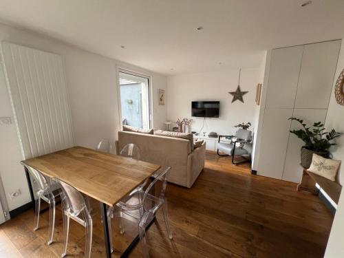 un salon avec une table et un canapé dans l'établissement Le cocon citadin atypique et son patio, à Tours