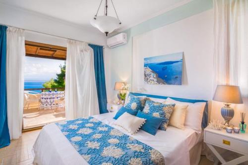 a bedroom with a bed with a view of the ocean at Villa Blue Lagoon in Afitos
