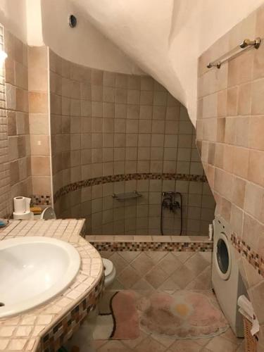 a bathroom with a sink and a toilet and a tub at Villa Blue Lagoon in Afitos