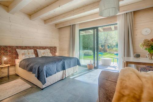 a bedroom with a bed and a large window at Kozia Chata in Brenna