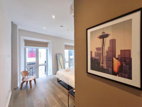 a bedroom with a bed and a view of a city at Lesplanade By Wynwood House in Panama City