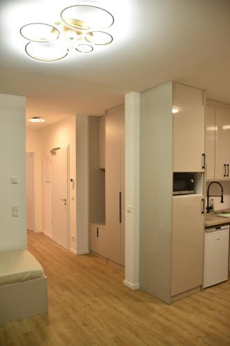 a living room with a kitchen and a chandelier at City Apartment Dresden 3 in Dresden