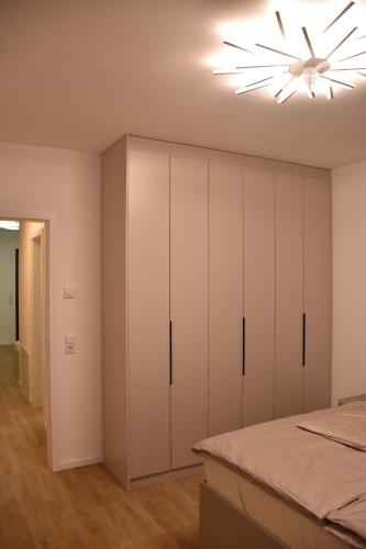 a bedroom with white cabinets and a ceiling fan at City Apartment Dresden 3 in Dresden
