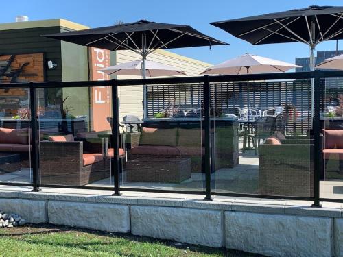 a restaurant with chairs and tables with umbrellas at Delta Hotels by Marriott Sault Ste. Marie Waterfront in Sault Ste. Marie