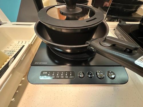 a pot sitting on top of a stove at Stella 202 エアコン付 無料WiFi Netflix in Sapporo