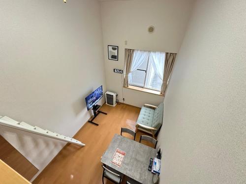 an overhead view of a living room with a table and chairs at Stella 202 エアコン付 無料WiFi Netflix in Sapporo