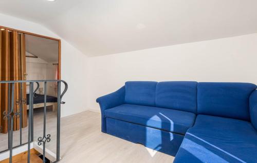 a blue couch in a room with a mirror at Kameni biser in Jurdani