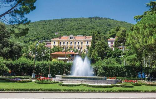 a fountain in a park in front of a building at Kameni biser in Jurdani