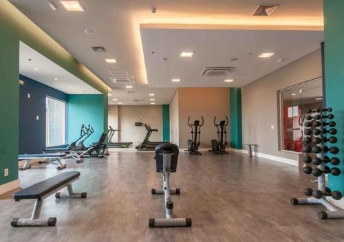 a gym with treadmills and exercise equipment in a room at Ideal para famílias, hospede-se no Solar das Águas. in Olímpia