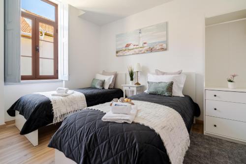 a bedroom with two beds and a window at HostWise - Traditional House with Terrace in Porto