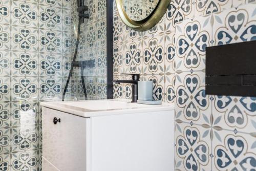a bathroom with a sink and a mirror on a wall at Kozia Chata in Brenna