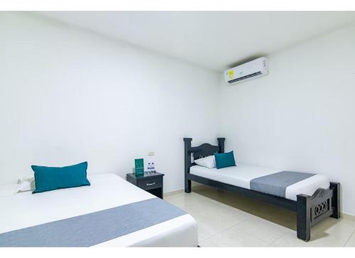 Ένα ή περισσότερα κρεβάτια σε δωμάτιο στο Hotel Caribe Confort
