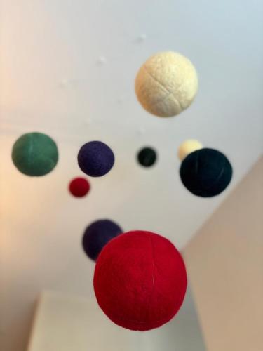 a group of different colored balls on a white wall at Kozia Chata in Brenna