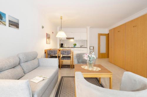 a living room with a couch and a table at Kaiserhof 42-44 Meereskrabbe in Kellenhusen