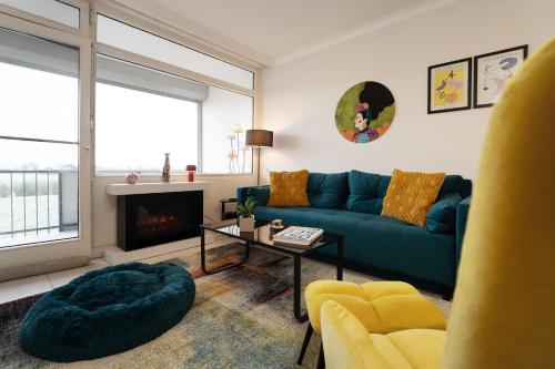 a living room with a blue couch and a fireplace at Naggi in Süssau