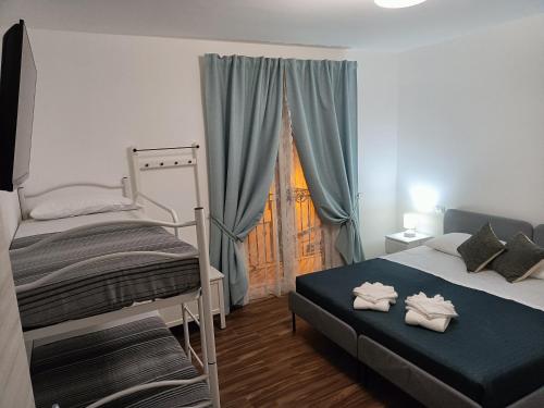 a bedroom with a bunk bed and a window at ATHENA in Scilla