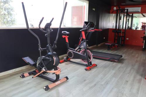 a gym with three exercise bikes in a room at Reserve Hotel in Surubim