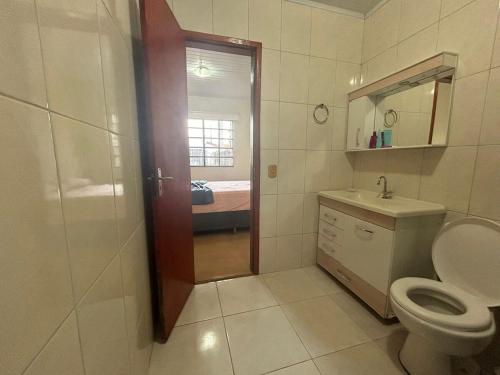 a bathroom with a toilet and a sink at Casa ampla com 02 suítes e 01 quarto próx das Cataratas e Aeroporto in Foz do Iguaçu