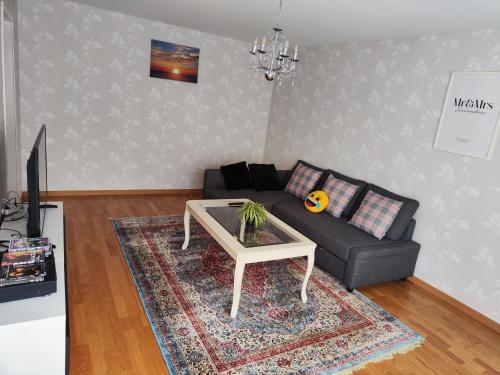 a living room with a couch and a coffee table at The castle & stay in Örebro
