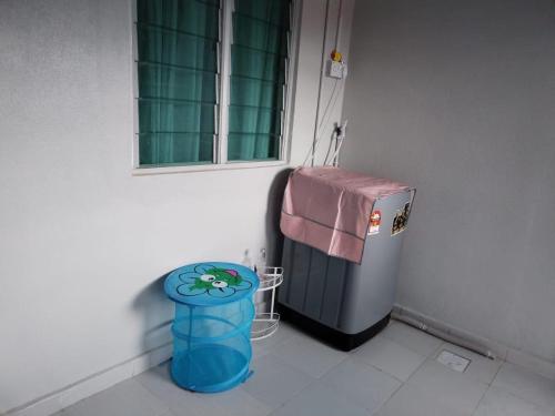 a room with a small refrigerator and a trash can at Aisya homestay Jeli Kelantan in Jeli