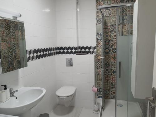 a bathroom with a toilet and a sink and a shower at ODI RENT - Le 60 in Le Blanc-Mesnil