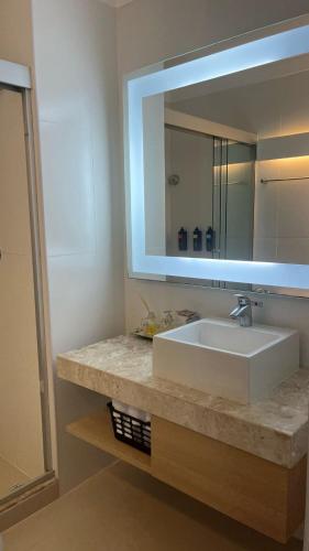 a bathroom with a white sink and a mirror at flat em Santos quadra da praia in Santos