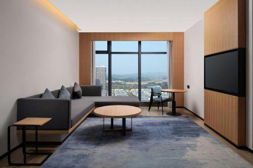 a living room with a couch and a tv at Fairfield by Marriott Taishan in Jiangmen