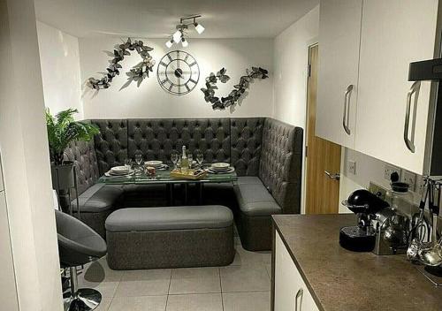 a living room with a table and a couch at Igloo Magnolia Room Stay I Breakfast I Free Parking in Leeds