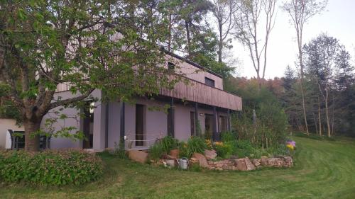 a house with a garden in front of it at Gîte Le Charme d'Argent in Charmois-devant-Bruyères