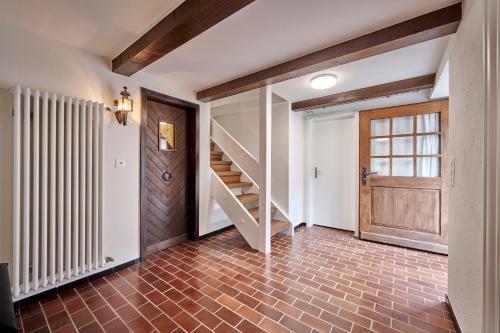 a hallway with a staircase and a wooden door at Chalet Mountain Love, spectacular views, spacious & luxurious in Lauterbrunnen