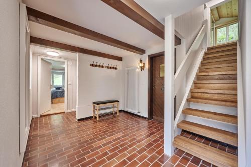 a staircase in a home with aoyer with wooden floors at Chalet Mountain Love, spectacular views, spacious & luxurious in Lauterbrunnen