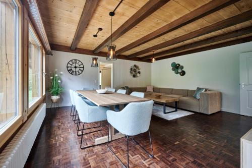 a living room with a table and chairs and a couch at Chalet Mountain Love, spectacular views, spacious & luxurious in Lauterbrunnen