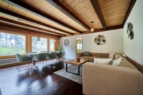 a living room with a couch and a table and chairs at Chalet Mountain Love, spectacular views, spacious & luxurious in Lauterbrunnen