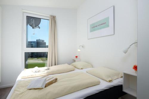 Postel nebo postele na pokoji v ubytování Marina Wendtorf Penthouse Kiek ut
