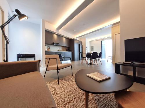 a living room with a couch and a table at Lesplanade By Wynwood House in Panama City